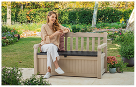 A woman is sitting on a wooden bench in a garden. AI generated content