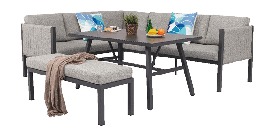 A grey couch and chair set up in a living room with a table in the center. A potted plant and a bottle are placed on the table. AI generated content