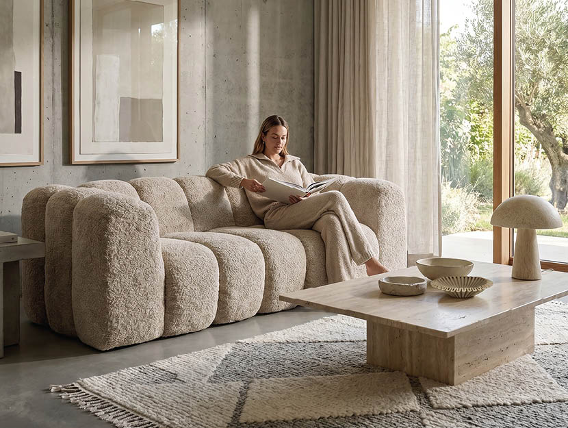 A woman is sitting on a couch in a living room. AI generated content