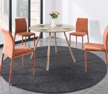 A round table with four chairs, two on each side, is set with plates and a vase of flowers. The table is surrounded by chairs, one on each side, and two on the opposite side. The table is set with plates and a vase of flowers. AI generated content