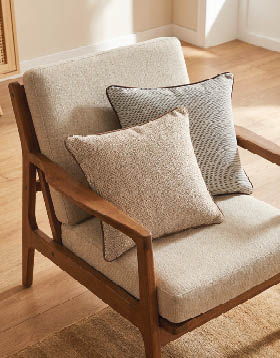 A wooden chair with two pillows on it. AI generated content