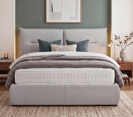 A bed with a white pillow and a tan headboard. AI generated content