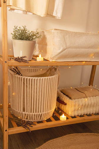 A shelf with a white basket and a plant on it. AI generated content